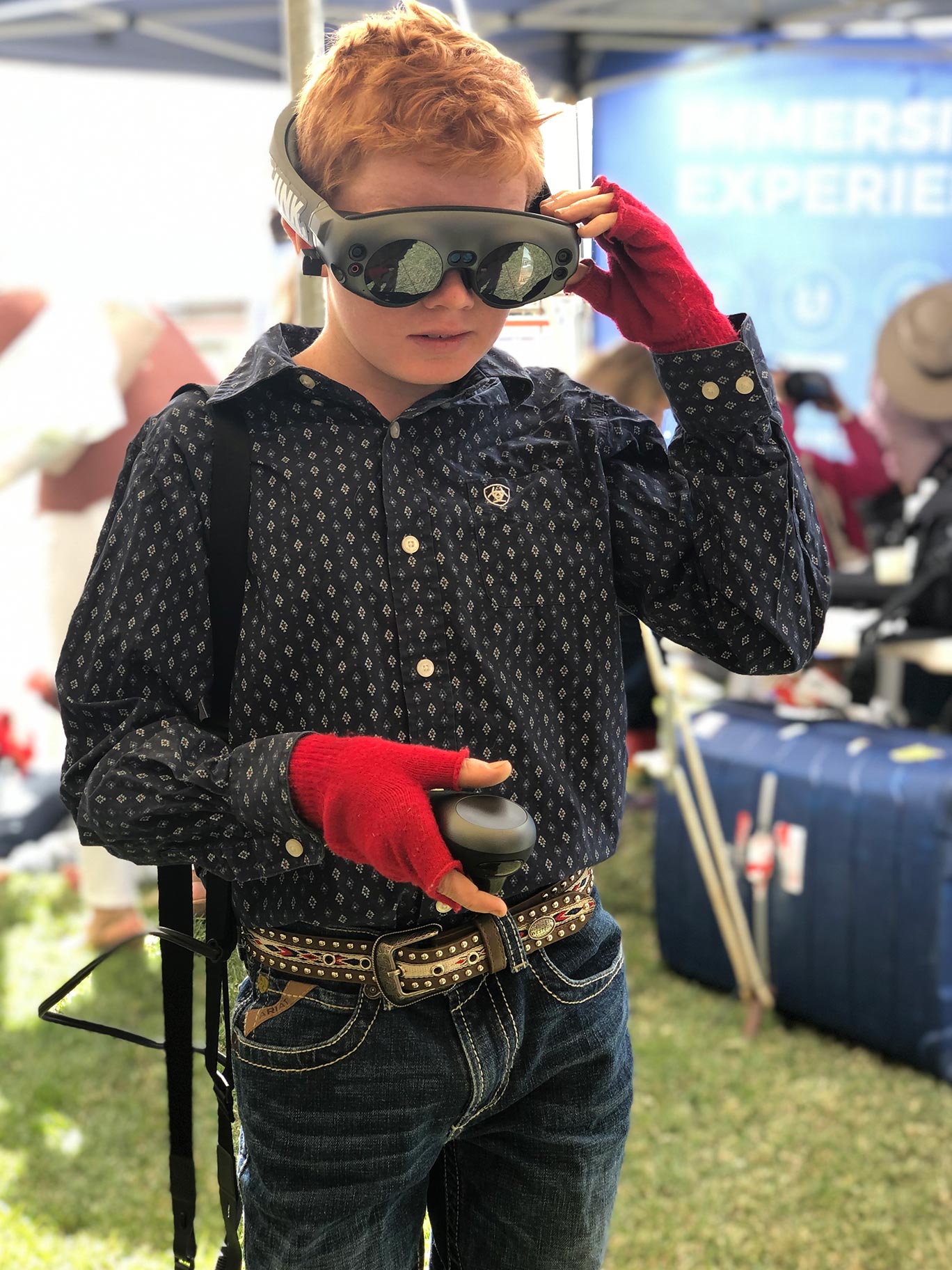 A boy holding his AR headset.